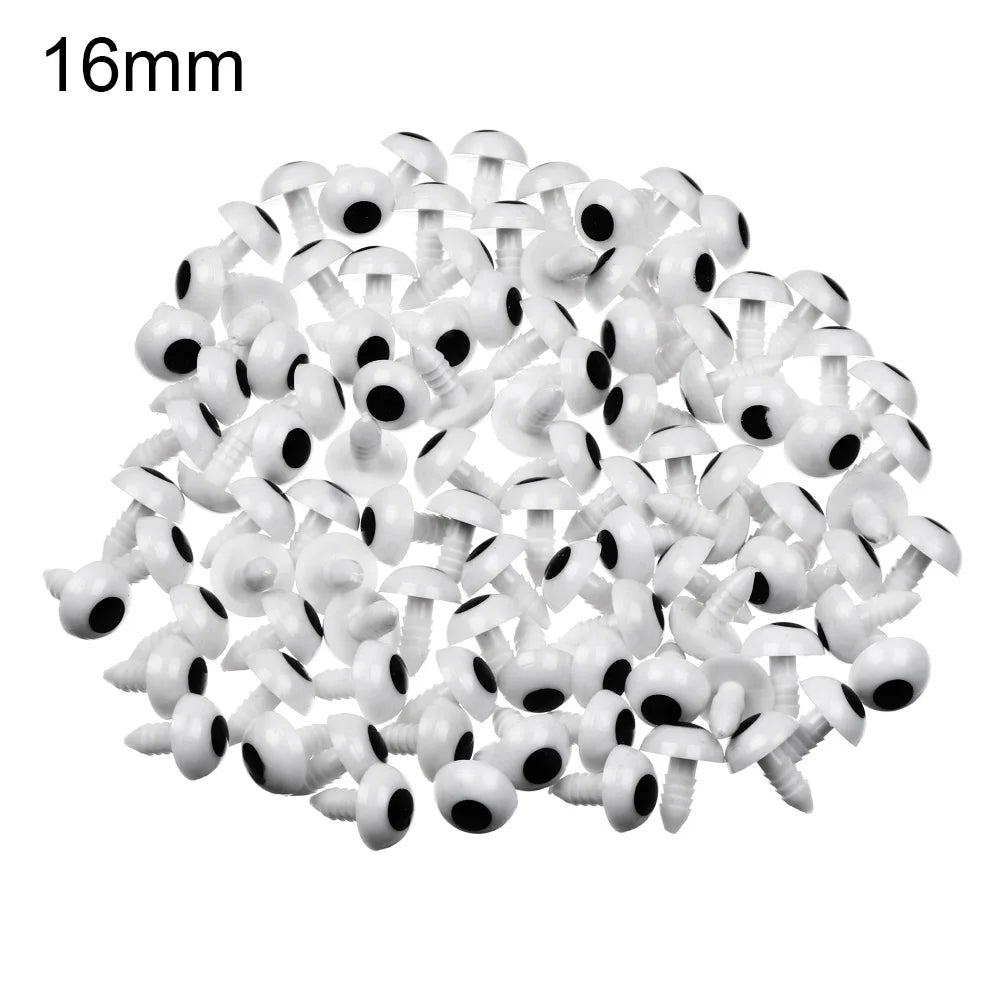 A pile of small white plastic safety eyes for crafting and stuffed animals