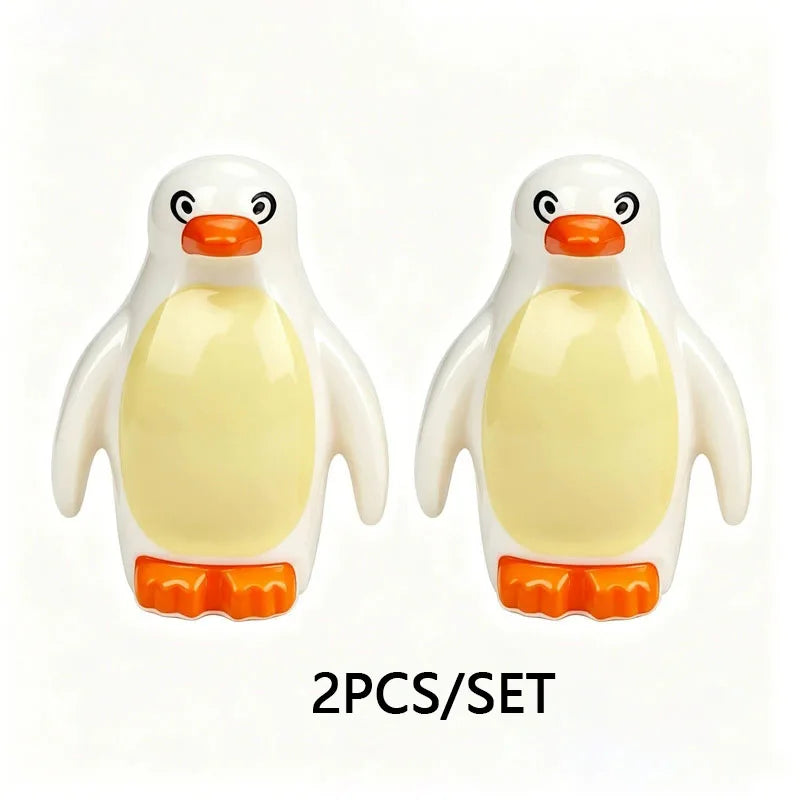 A set of two white and orange marine animal building blocks, resembling penguins or seals.