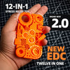 An orange 12-in-1 stress relief toy is held in a hand against a dark background.