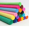 A collection of colorful crepe paper rolls in various shades of pink, green, blue, yellow, and purple.