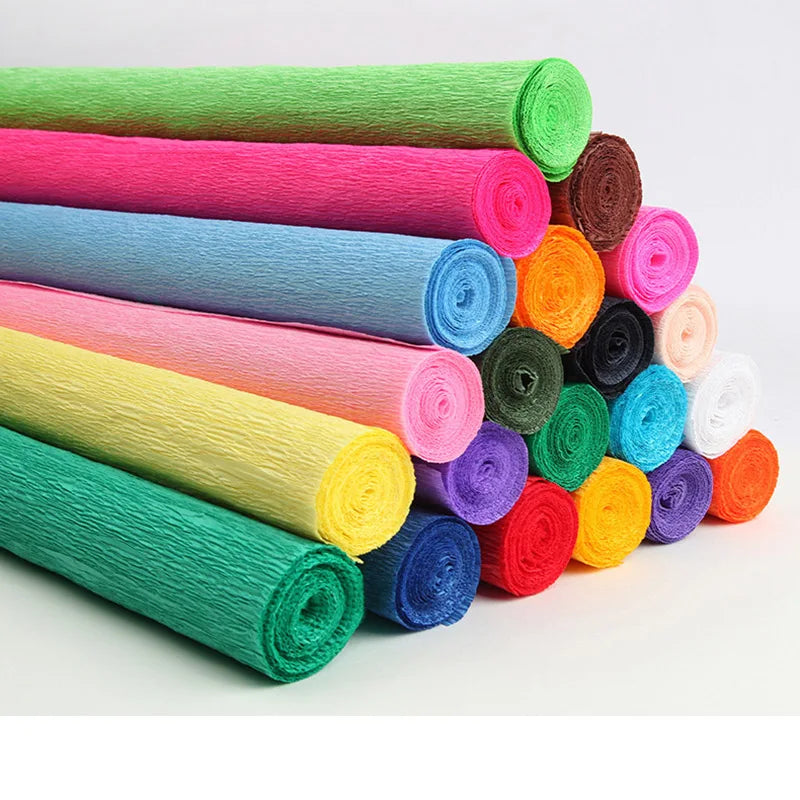 A collection of colorful crepe paper rolls in various shades of pink, green, blue, yellow, and purple.