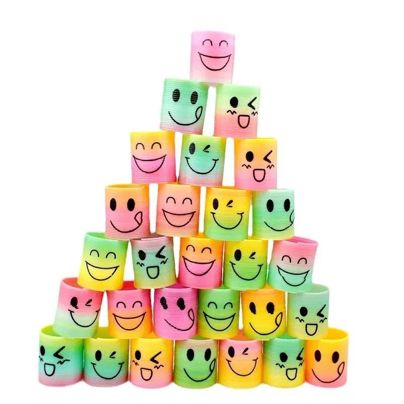 A stack of twelve colorful, smiling emoji-themed stacking circles in various pastel colors.