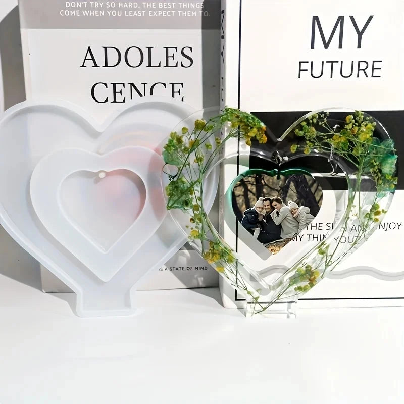 A silicone mold shaped like a heart is displayed in front of books titled Adolescence and My Future.
