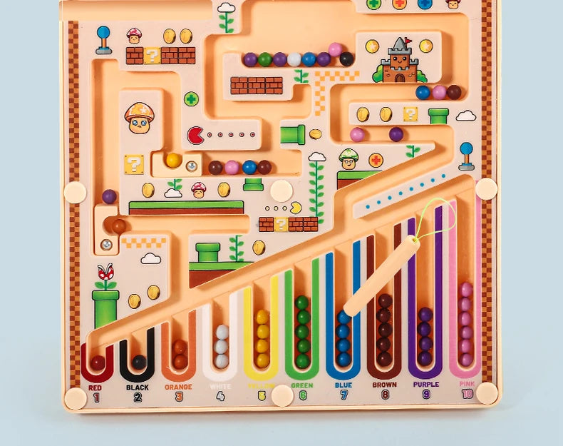 A magnetic maze educational ball game with colored balls and pathways on a wooden board.