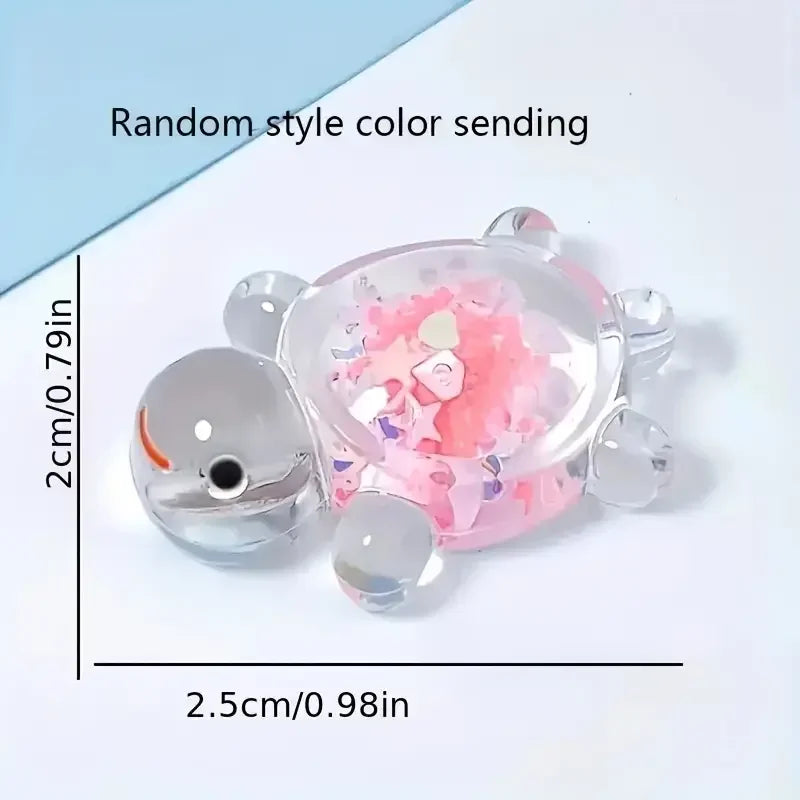 A clear, round sea turtle figurine with pink and purple glitter inside, used for aquarium or craft projects.
