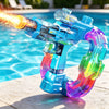 A blue electric water gun with a glowing projectile is shown resting on a concrete surface near a swimming pool.