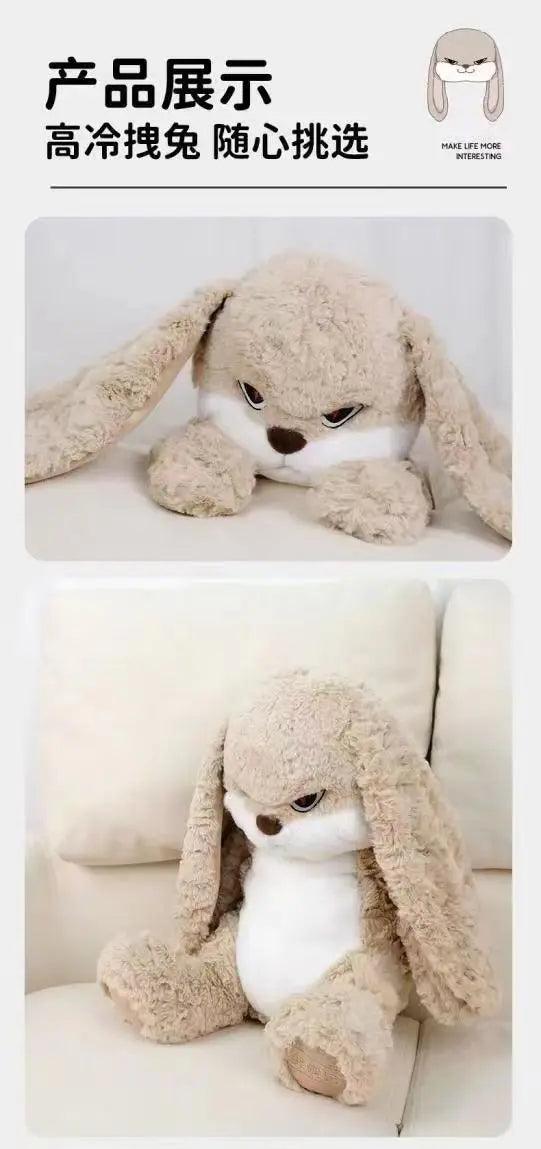 A light brown plush rabbit toy is shown lying down on a white surface.