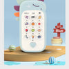 A light blue baby phone toy with a screen showing numbers and icons, resting on a wooden surface.