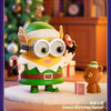 A green Minion collectible figure wearing a white shirt and brown belt, standing on a white surface.