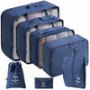 A set of navy blue travel packing cubes and a storage bag with light beige lining.