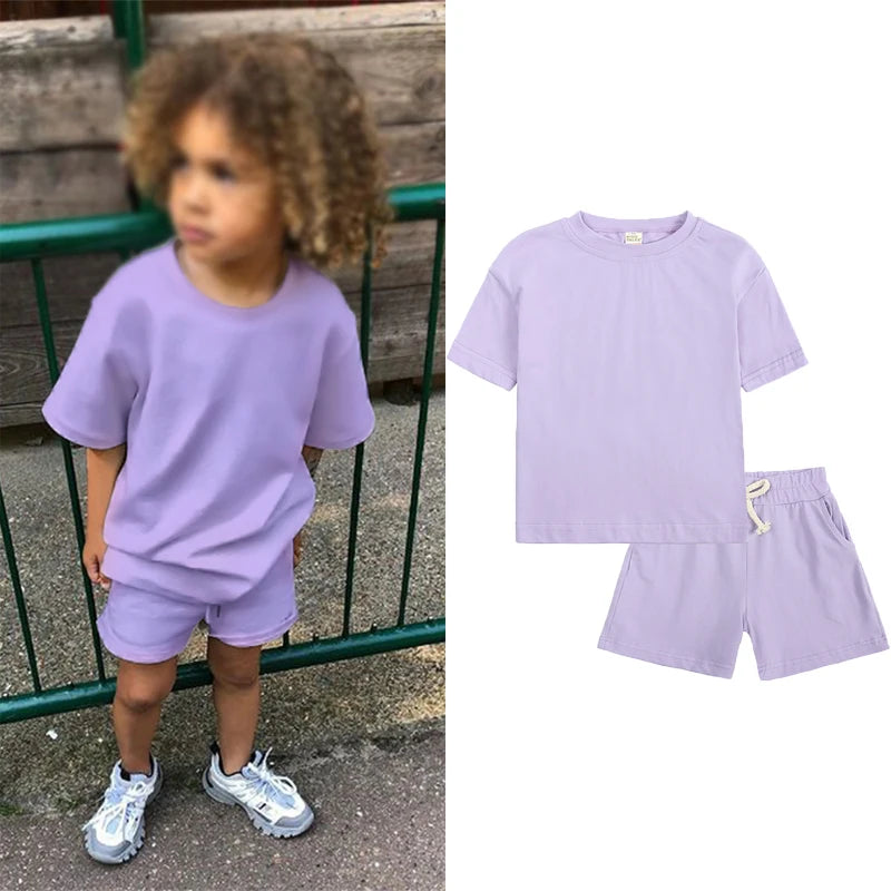 A purple kids summer tracksuit set featuring a short sleeve top and matching shorts.