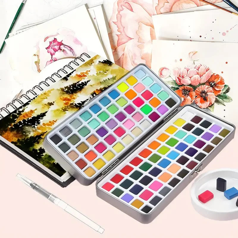 A complete watercolor paint set featuring a palette of vibrant colors, brushes, and pencils displayed on paper.