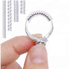A hand holds a transparent ring size adjuster set, showing the adjustable ring and various sizes.