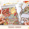 A hand holds an open sticker book featuring a detailed, colorful scene of a tiny DIY pocket cabin or village.