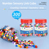 A collection of colorful linking cubes and ten-colored cubes are displayed in jars and scattered on a surface.