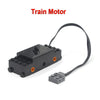 A black Train Motor with a wire connector is shown on a white background.