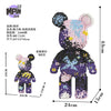 A small bear figure made of micro building blocks featuring a graffiti art design.