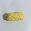 A light yellow, elongated peanut-shaped squishy stress ball with a textured surface.