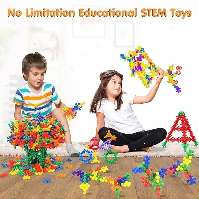 A girl and a boy are playing with colorful interlocking plastic building blocks to create various shapes.