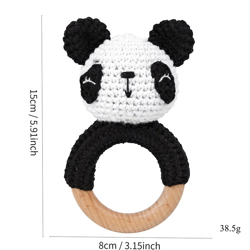 A cute panda-shaped wooden rattle and teether ring with black and white fur texture.