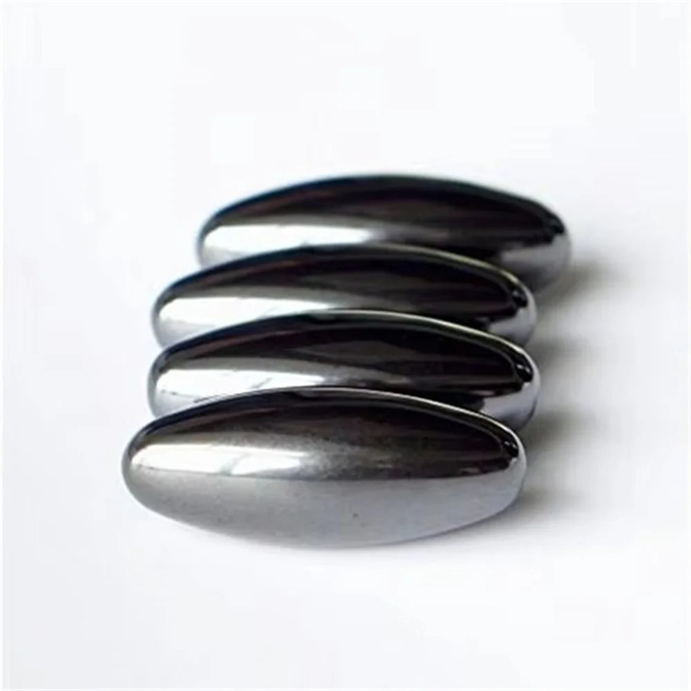 A stack of smooth, oval magnetic olive snake egg fidget toys with a metallic silver finish.