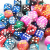 A close-up view of a mixed-color dice set featuring various translucent and opaque dice for board games.
