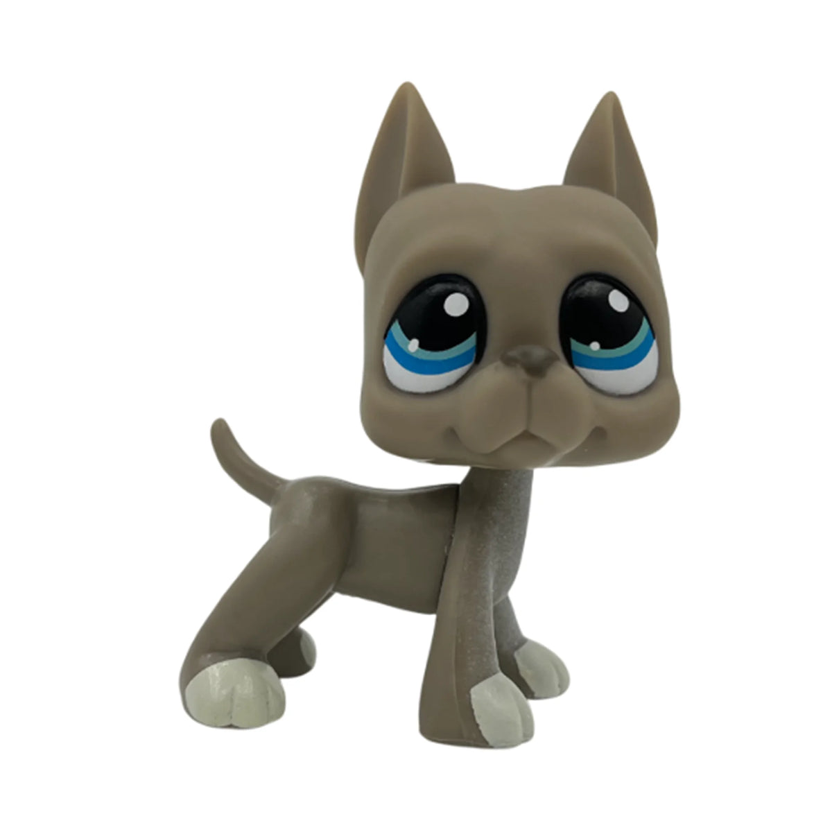 A small, gray pet figurine of a kitten with blue eyes.