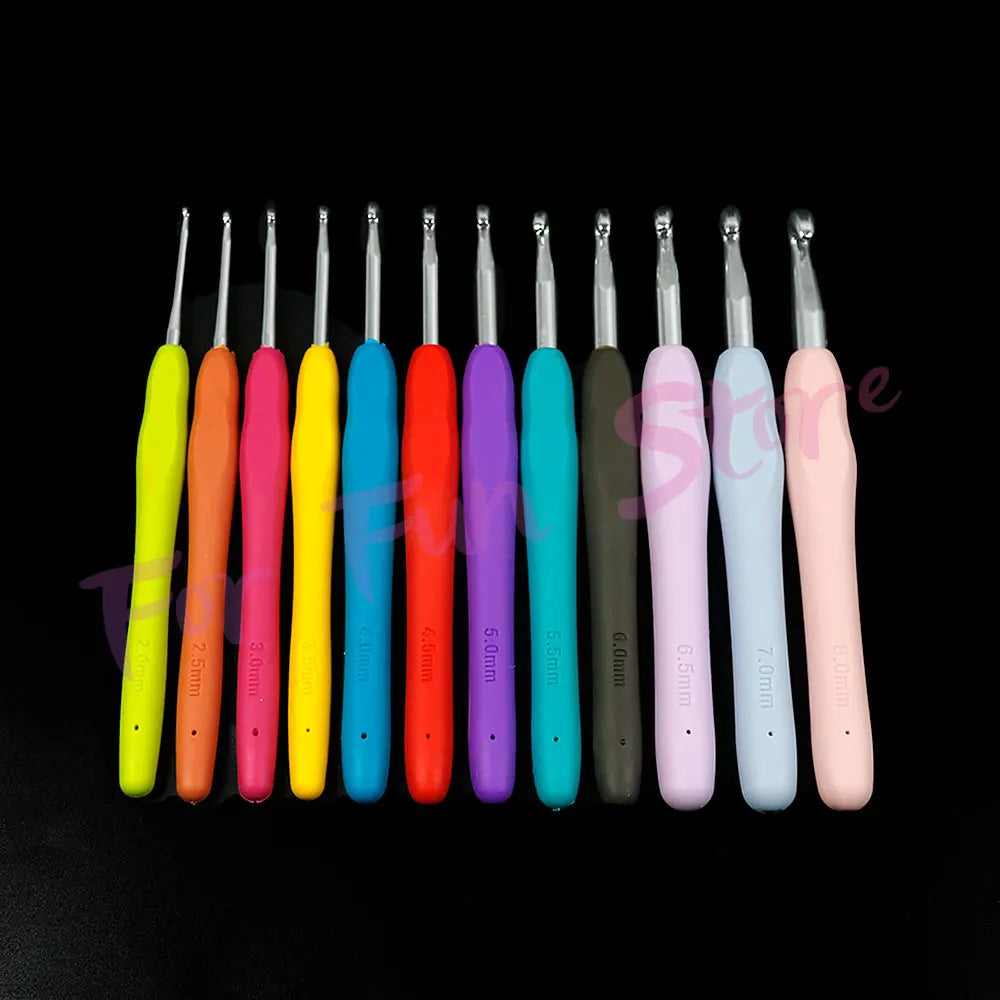 A row of colorful crochet hooks and knitting needles in various colors displayed against a black background.
