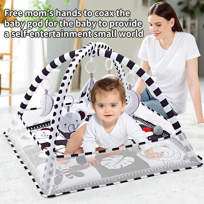 A mother is shown using a multifunctional baby play mat with a fitness frame and hanging toys for a baby.
