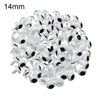 A pile of small white plastic safety eyes for crafting and stuffed animals.