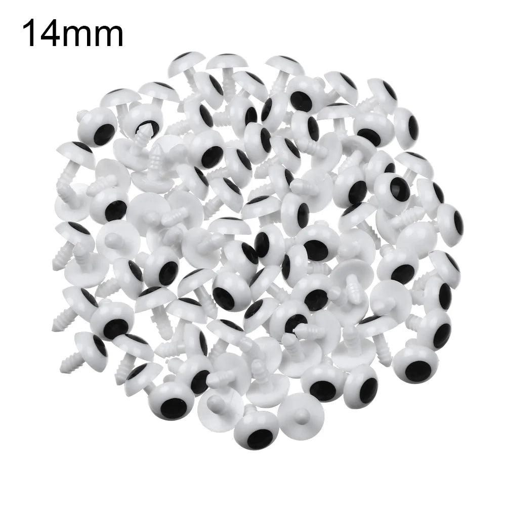 A pile of small white plastic safety eyes for crafting and stuffed animals.