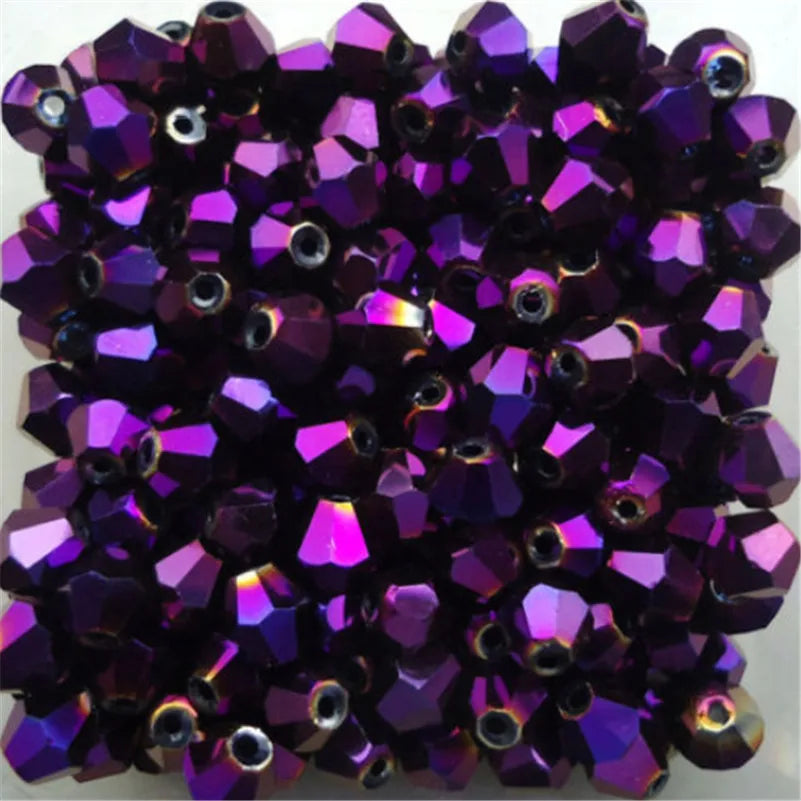 A cluster of deep purple faceted glass bicone beads for jewelry making