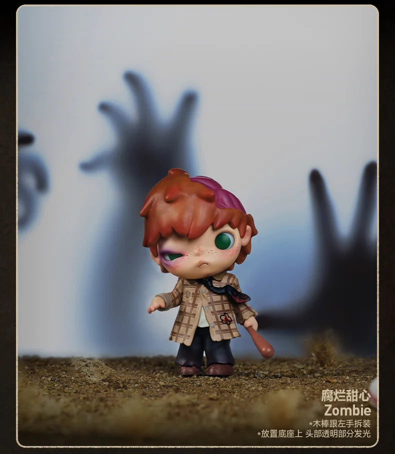 A collectible figure of an orange-haired monster with large eyes standing on a textured surface.