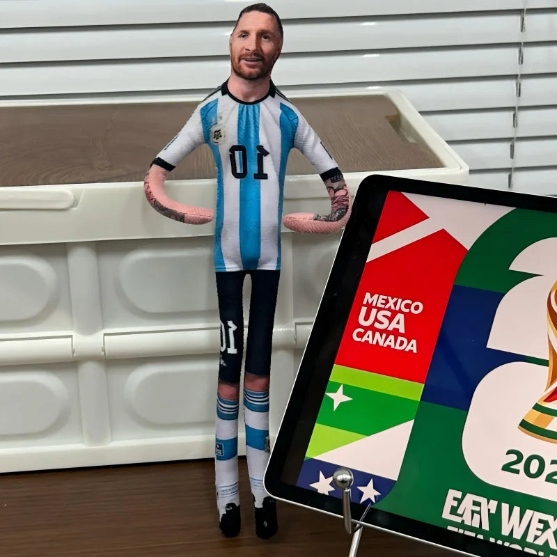 A male figure dressed in a soccer jersey with the number 01 stands in front of a white box and a sign displaying country flag