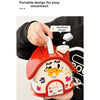 A hand holds a red house-shaped piggy bank with a lid and key, featuring cute animal designs.