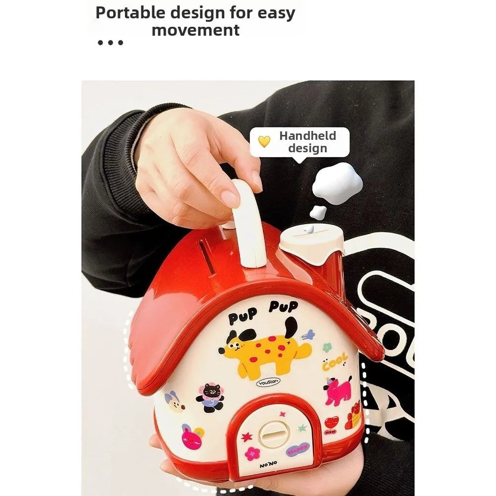 A hand holds a red house-shaped piggy bank with a lid and key, featuring cute animal designs.