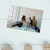 A framed jigsaw puzzle featuring a family portrait of a mother, father, and child sitting together.