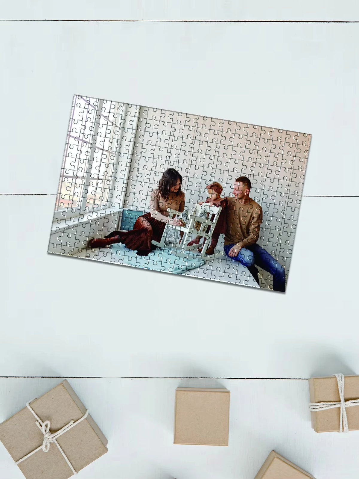 A framed jigsaw puzzle featuring a family portrait of a mother, father, and child sitting together.