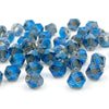 A collection of faceted blue crystal glass beads in various sizes and shapes for jewelry making