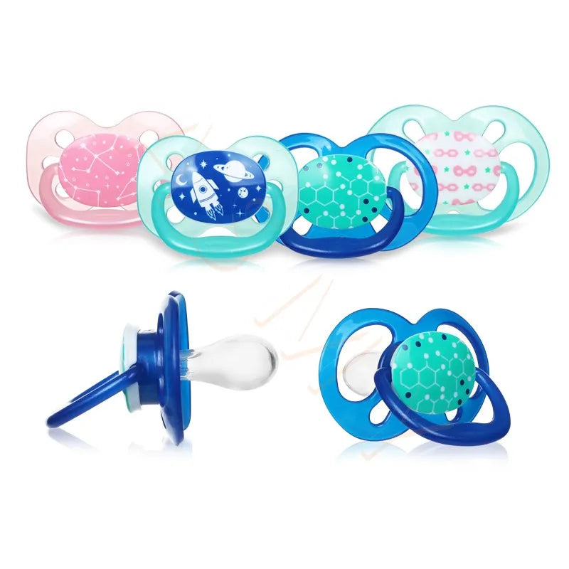 A set of soft silicone baby pacifiers and soothers in pink, blue, and green colors.