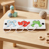A wooden Montessori busy board featuring colorful animal shapes and sensory elements for toddlers.