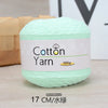 A ball of light green 100% cotton yarn labeled as Cotton Yarn, measuring 17 cm.