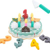 A wooden pretend play tea party set featuring a red number one cake and various colored food items.