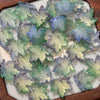 A collection of translucent green and blue maple leaf glass beads for DIY jewelry making.