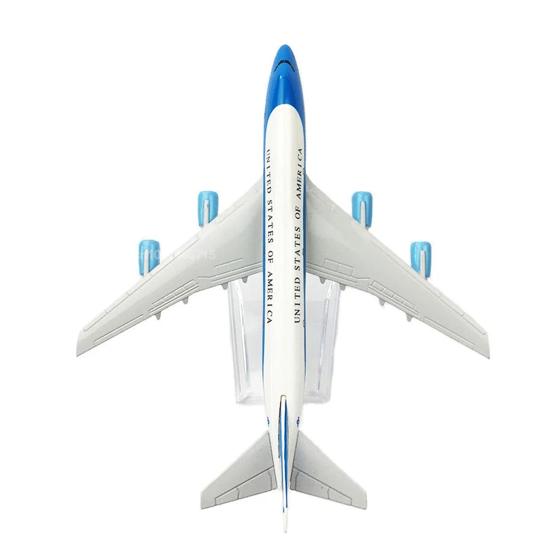 Diecast Boeing airplane model with a blue nose cone and white wings displayed against a white background.