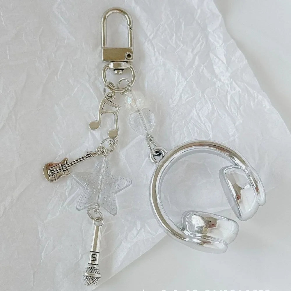 Silver beaded wing cross phone lanyard keychain attached to a clear phone ring.