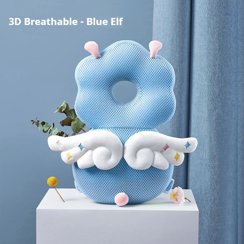 A blue elf shaped soft silicone head protection pillow with white wings and green leaves displayed on a white surface.