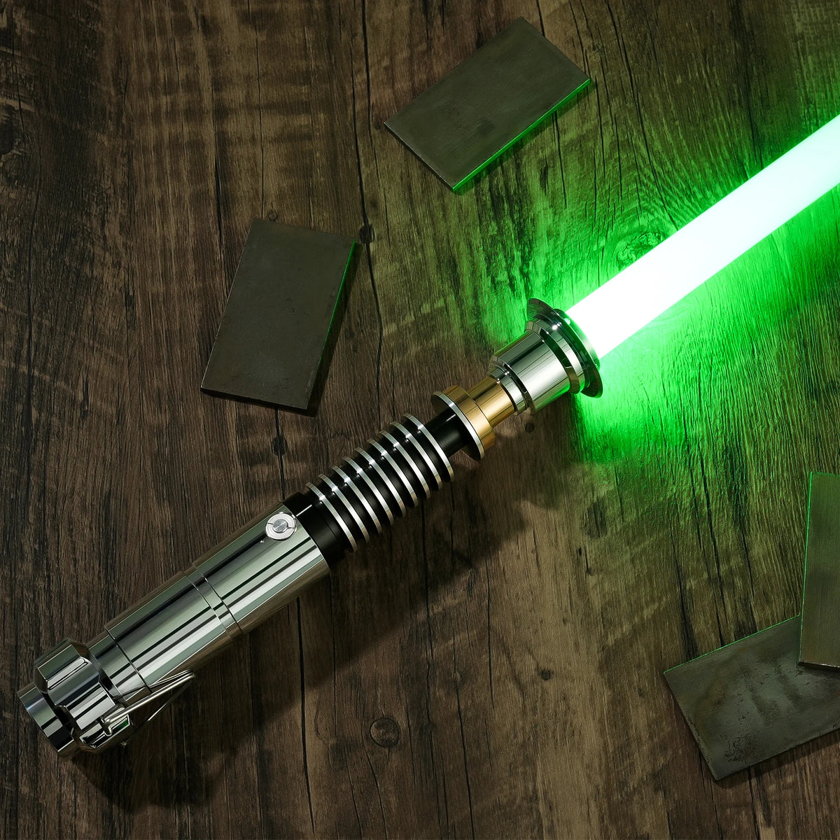 Accessoire d'épée laser avec une lame verte luminescente posé sur une surface en bois sombre.