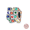A collection of colorful, faceted gemstones set in silver cubes forming a rotatable Rubik's cube charm.