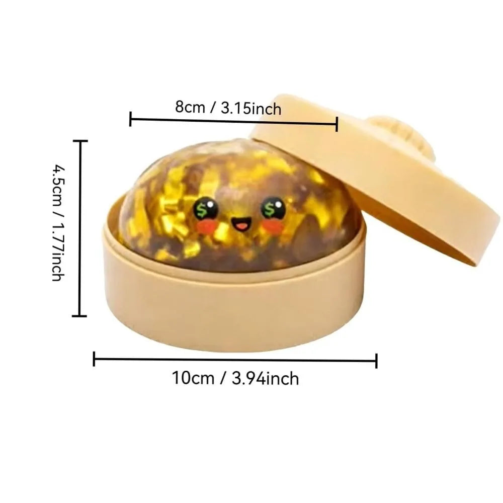 A squishy fidget toy shaped like a glitter shark dumpling inside its light beige steamer box.